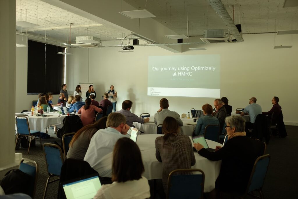 The team talking in front of the audience at the GDS conference