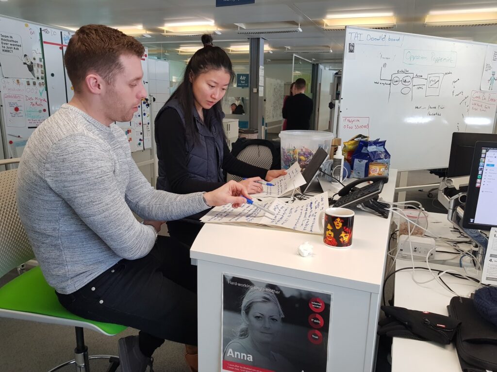 A male and female sitting at a desk with handwritten notes