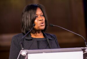 Jacky Wright speaking at a lecturn