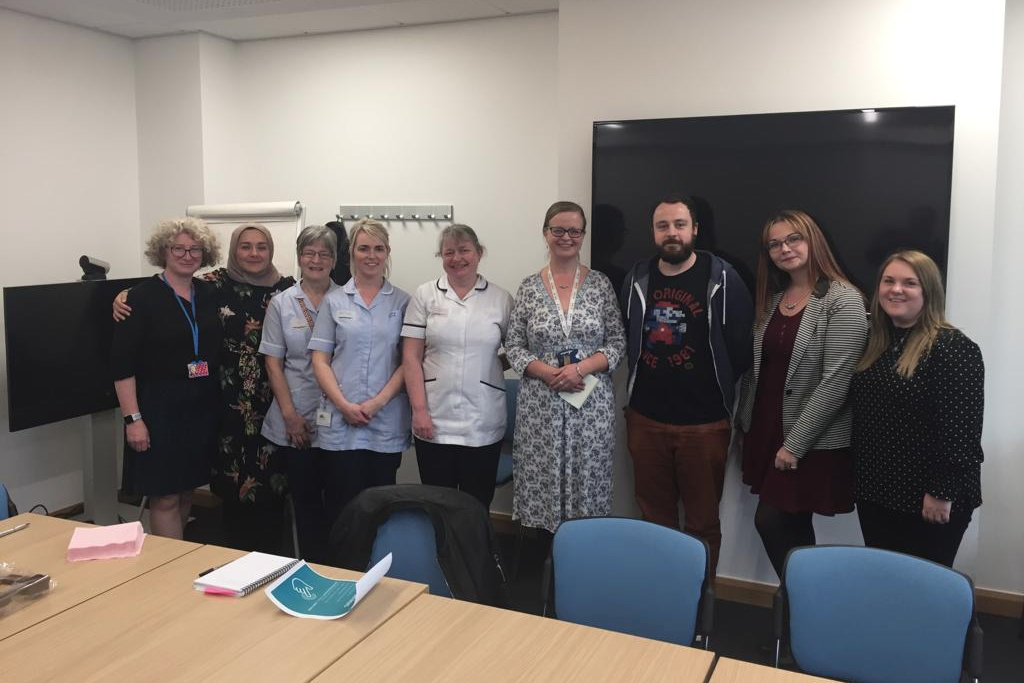 The NHS and HMRC men and women standing in a line at the event
