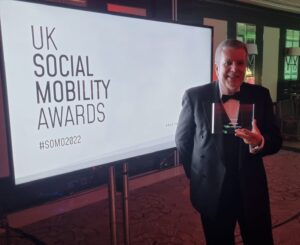 David Foster, holding his award from the UK Social Mobility Awards