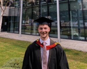 Matthew in his graduation gown and mortarboard 